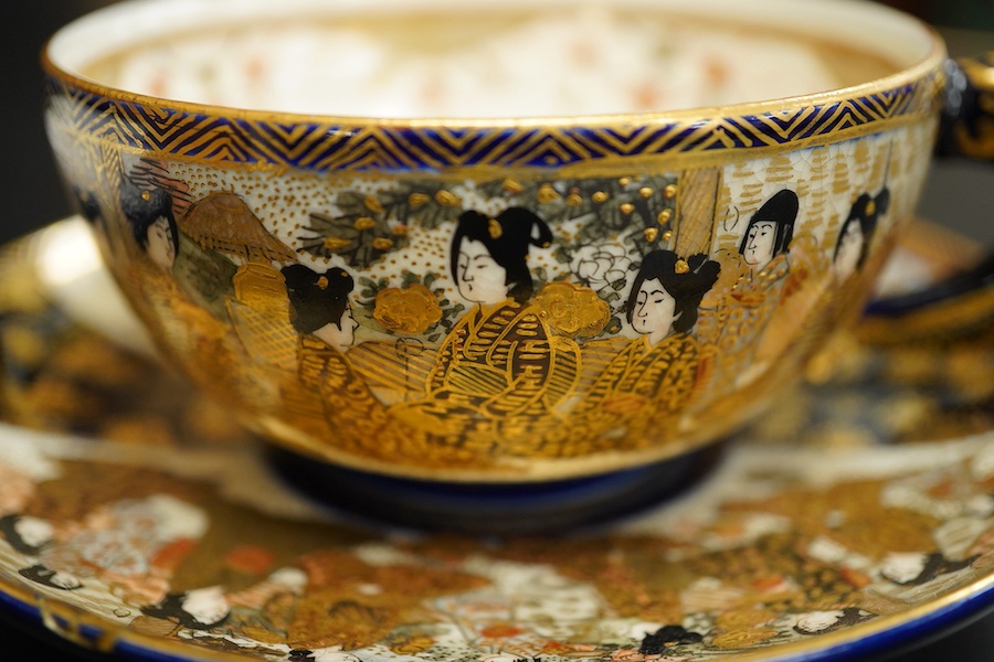 A Japanese satsuma pottery cup and saucer, saucer 14cm in diameter
